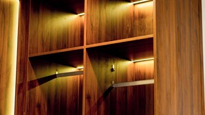 A wooden interior with built-in shelves and a metal rack. - Kevin Hung Hotel (Hoa Lu)