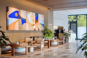 A modern lobby with a large abstract painting, seating area, and a bar. - Jen Hangzhou By Shangri-La (Hangzhou)