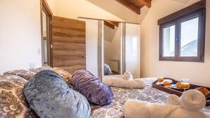 A bedroom with a bed, pillows, a tray with drinks, and towels. - Villa Camila 6 - La Panera (Villarraba)