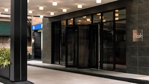 A modern building entrance with glass doors, a sign reading 'The Lash,' and recessed lighting. - Nester Finn Grand Central (New York)