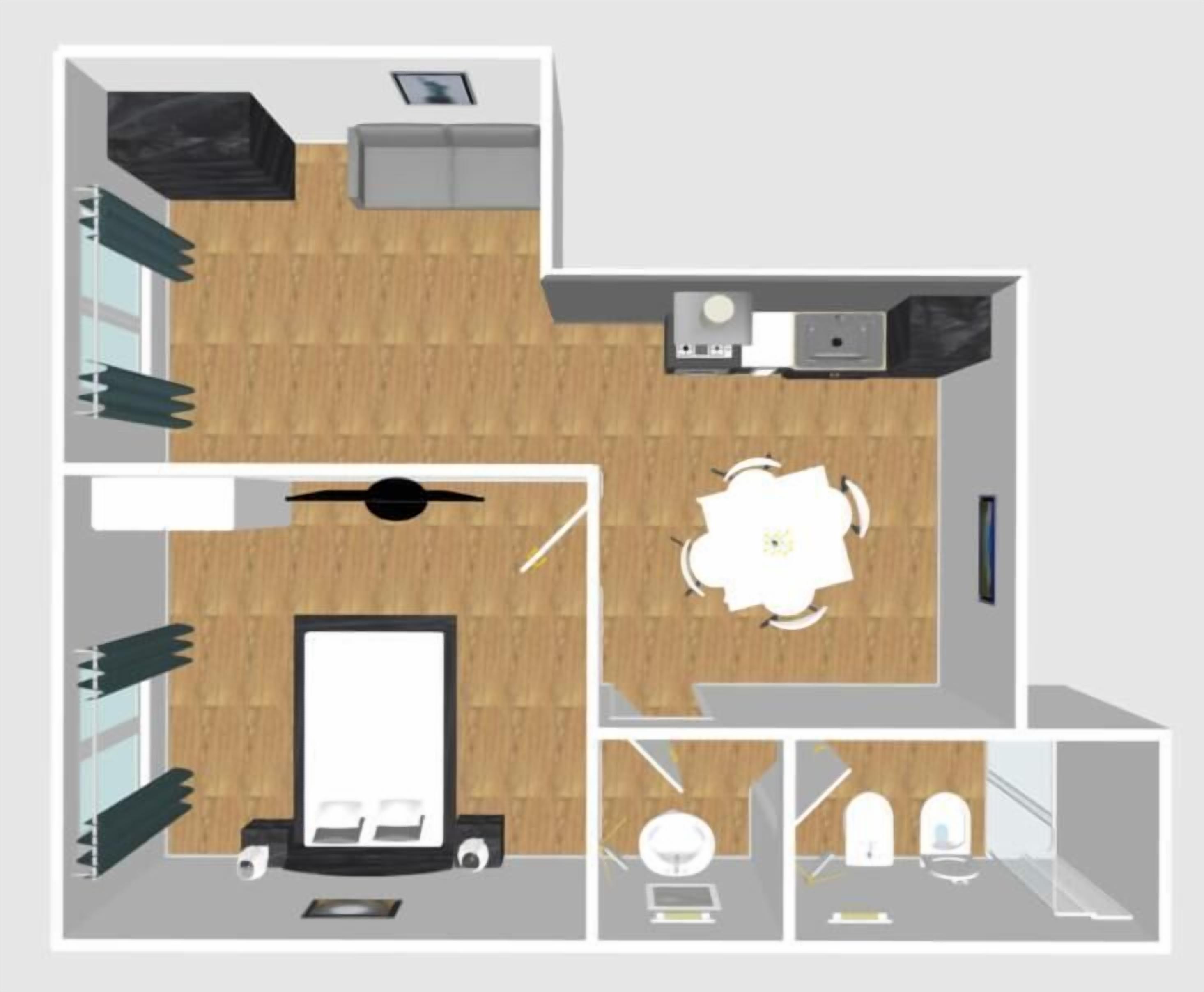 A hotel room layout with a bed, bedside table, wardrobe, and a small sitting area with a chair and table.