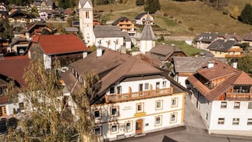 A traditional European town with a prominent church, a restaurant, and a variety of residential buildings.