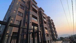 A multi-story building with balconies, large windows, and a modern architectural design. - Apartments at Abrish by Karibu Stays (Kampala)