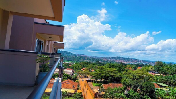 A balcony with a view of a cityscape, including buildings and greenery. - Apartments at Abrish by Karibu Stays (Kampala)