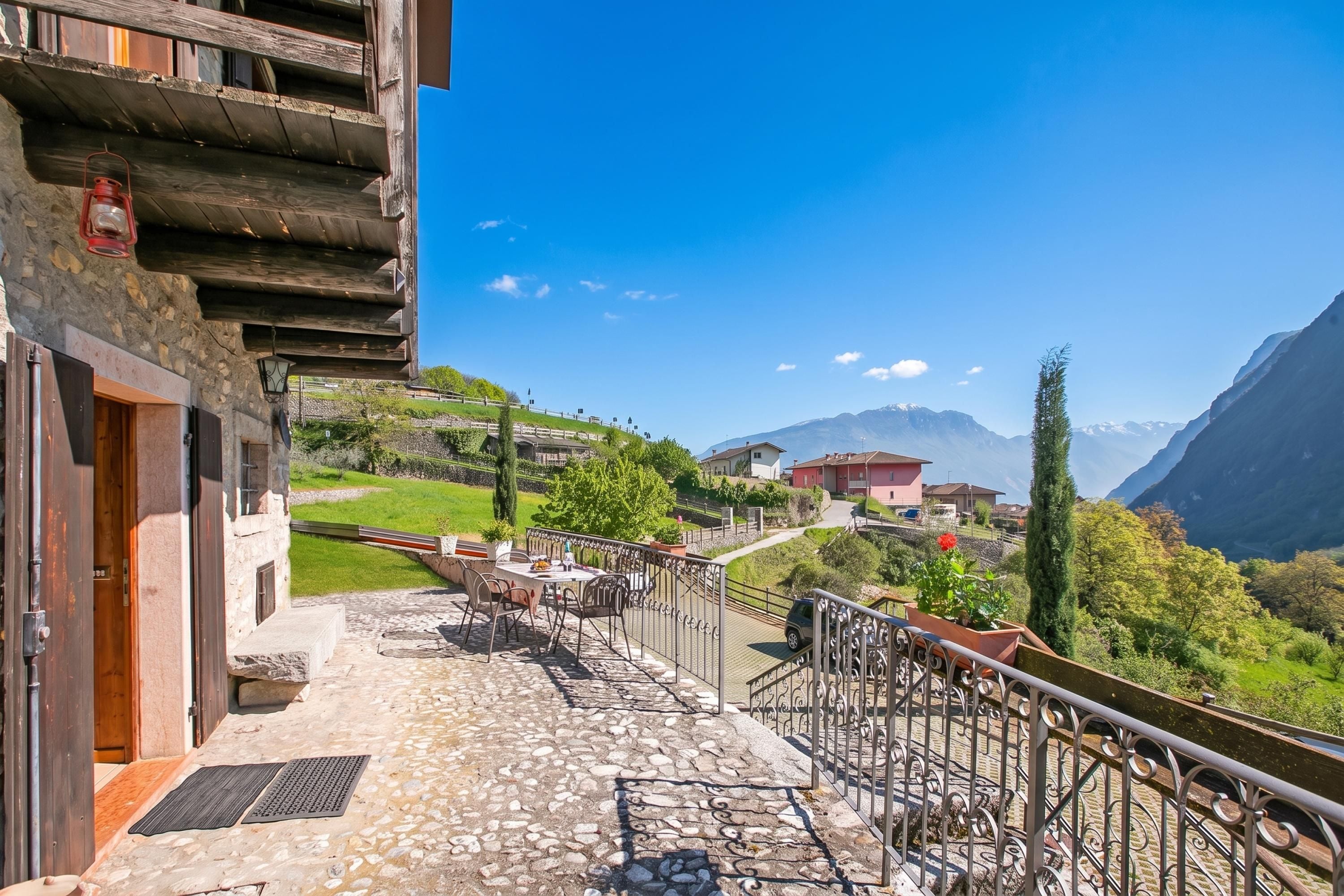 A stone balcony with a view of a mountain landscape.