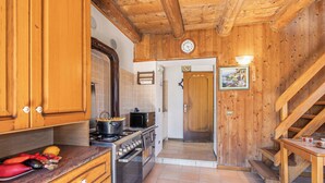 A kitchen with wooden cabinets, a stove, and a microwave. - Private Green Oasis - Terrace (Tenno)