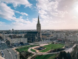 A cityscape with a prominent tower, a roundabout, and surrounding buildings.