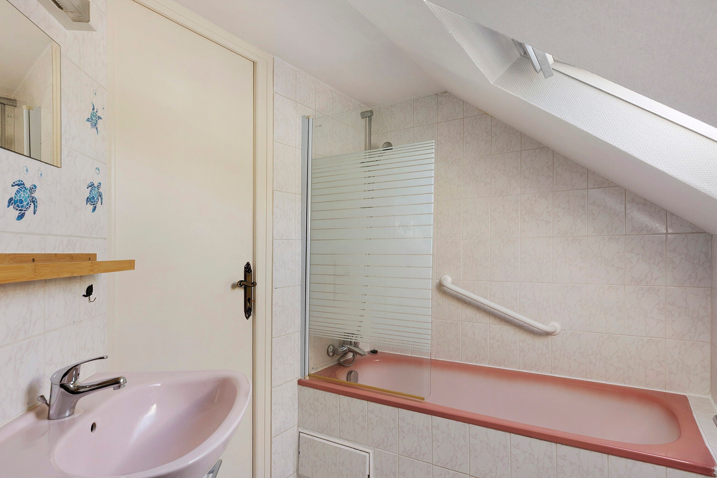 Une salle de bain équipée d’un lavabo, d’une baignoire et d’une douche.