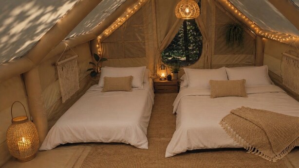 A cozy tent-style room with two beds, string lights, and a hanging lantern. - Anna Glamping (Anna)