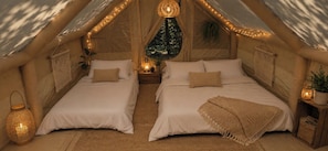 A cozy tent-style room with two beds, string lights, and a hanging lantern. - Anna Glamping (Anna)