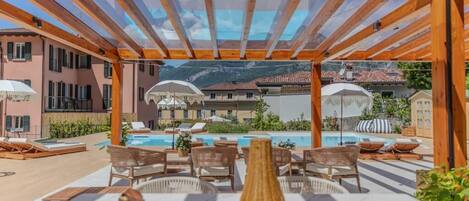 Seasonal outdoor pool, open 11:00 AM to 8:00 PM, pool umbrellas