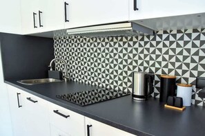 Fridge, stovetop, dishwasher, coffee/tea maker