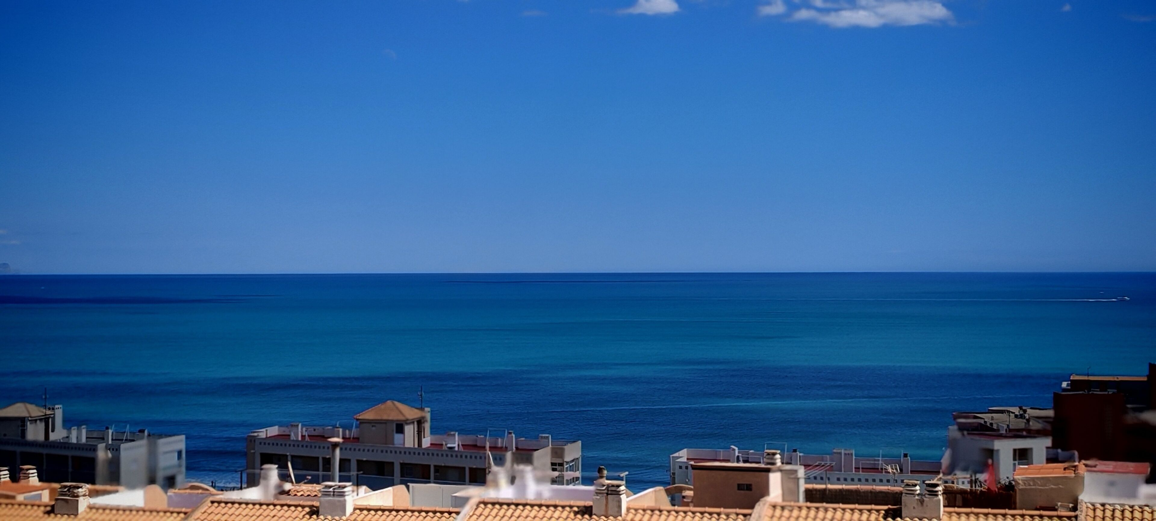A coastal view with buildings and the sea.