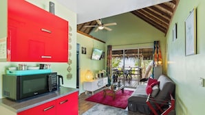 A compact living space with a kitchenette, a dining area, and a seating area with a view.