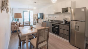 A modern kitchen with a dining area, stainless steel appliances, and a view to the outside. - Elegance in Barranco - Cozy 2BR (Lima)