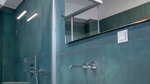 A modern bathroom with a large white sink, a glass shower enclosure, and a mirror above the sink. - Lumiere Villa Andromeda 3 (Preveza)