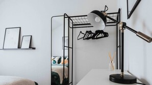 A bunk bed with a mirror, a desk with a lamp, and a shelf with framed pictures. - 3 Mins to Stadium W M Dishwasher Sofa Bed (Liverpool)