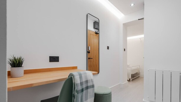 A modern bathroom with a wooden vanity, a mirror, a potted plant, and a radiator. - Work Desk Private Ensuite Minifridge Parking (Liverpool)