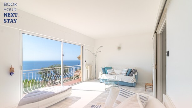 A spacious balcony with a view of the sea, a cozy seating area with a sofa and pillows, and a modern light fixture. - Family Villa-sea View Pool and Garden Near Monaco (Roquebrune-Cap-Martin)