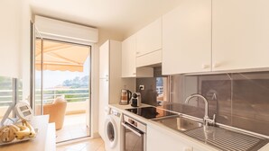 A modern kitchen with a washing machine, a coffee maker, and a sink. - High-end Residence With Pool and Panoramic Views (Beausoleil)