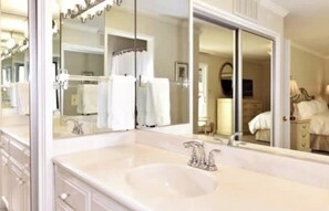 A hotel bathroom with a large mirror, a sink, and a vanity. - Napa Escape Luxe King Bed Near Wineries Spa (Napa)