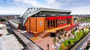 A stadium with a distinctive roof structure and a prominent entrance. - Great for Longer Stays W M Smart TV Parking (Liverpool)