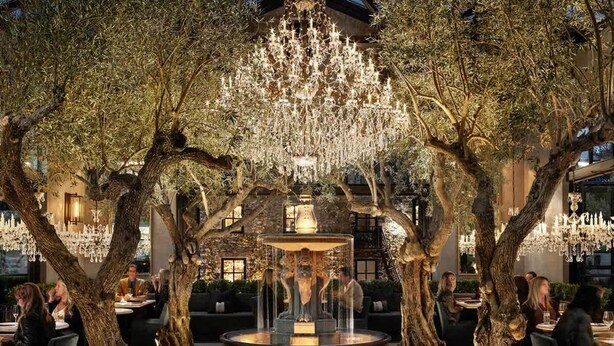 An outdoor dining area with trees, a fountain, and chandeliers. - Elegant Napa Retreat Luxe Beds Prime Location (Napa)