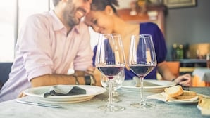 A dining table with two wine glasses, plates, and bread. - Elegant Napa Retreat Luxe Beds Prime Location (Napa)
