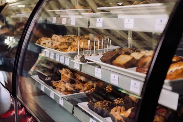 A bakery display case with various baked goods.