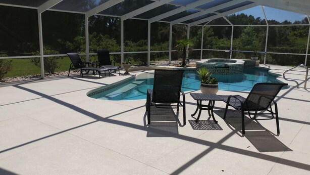 A covered outdoor area with a swimming pool, lounge chairs, and a hot tub. - Villa Corthouts Luxury Home Close to Bike Trail (Inverness)