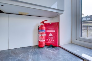 A fire extinguisher and a fire blanket on a window sill. - Perfect Booking 2 Bed Home in Leyton (London)