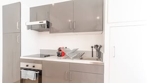 A modern kitchen with stainless steel appliances, a built-in oven, and a sink. - Nice Studio Close to Monaco (Beausoleil)