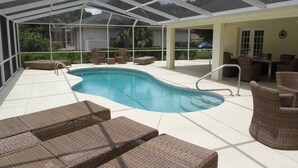 A covered outdoor swimming pool with lounge chairs and a patio area. - Villa Luva Spectacular Villa With Pool (Hernando)