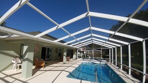 A covered swimming pool with a glass ceiling, a chair, and a table. - Villa Willow Wood 3-bedroom Home Private Pool (Inverness)