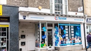 Un edificio con escaparate que muestra la leyenda 'Tennial Personnel Ltd.' y una entrada visible.