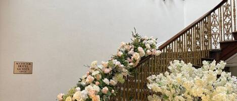 A staircase with ornate railings and floral decorations.