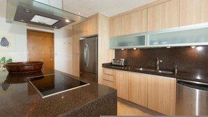 A modern kitchen with a stainless steel refrigerator, a built-in oven, a toaster, and a dishwasher. - Beautiful Beachfront 3 bd Condo in Nuevo Vallarta (Nuevo Nayarit)