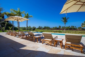 A poolside area with lounge chairs and umbrellas, surrounded by palm trees and a clear blue sky. - 3 bd Condo With Ocean Views HK (San Marcos)