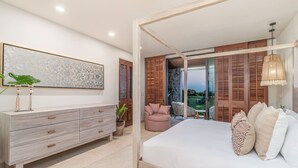A bedroom with a bed, a dresser, a chair, a potted plant, and a view of a balcony. - 3bd Condo Ocean Views Pool HK - Tower 5 (Punta de Mita)