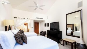 A hotel room with a bed, a television, a ceiling fan, a mirror, and a window. - 3 Bd Villa in Las Palmas Punta Mita Cook Golf-cart - Las Palmas 5 (Punta de Mita)