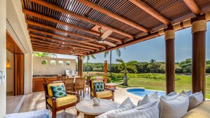 A covered outdoor seating area with a pool, wooden furniture, and a view of the landscape. - 3 Bd Villa in Las Palmas Punta Mita Cook Golf-cart - Las Palmas 5 (Punta de Mita)