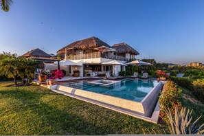 A resort with a swimming pool, thatched-roof structures, and lush landscaping. - 3bed- Ocean View Private Pool - Casa de las Aves Casita Zen 14 (Punta de Mita)