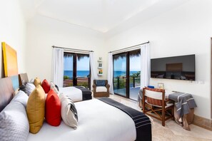 A hotel room with two beds, a desk, and a TV. - 3bed- Ocean View Private Pool - Casa de las Aves Casita Zen 14 (Punta de Mita)