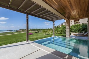 A pool with a view of the ocean, a covered area with a wooden ceiling, and a well-maintained lawn. - Las Marietas D101 Punta Mita Private Pool (Punta de Mita)