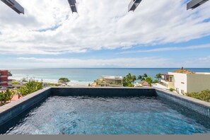 A swimming pool with a view of the ocean and buildings. - Naya 6401 Tower VI in Bahia de Banderas (Punta de Mita)