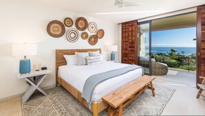 A bedroom with a bed, bedside tables, a bench, a ceiling fan, and a view of the ocean through a sliding door. - 3 bed 3 5 Bath Private Pool Wide Ocean Views Condo Cualli (Punta de Mita)
