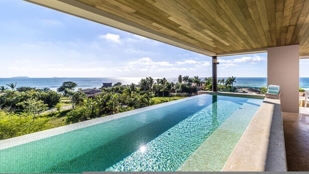 A pool with a view of the ocean, surrounded by greenery and a wooden ceiling. - 3 bed 3 5 Bath Private Pool Wide Ocean Views Condo Cualli (Punta de Mita)