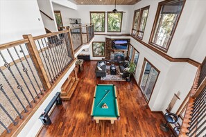 A spacious indoor area with a pool table, seating, and a fireplace. - Deja View - Upper Unit (Hayden)