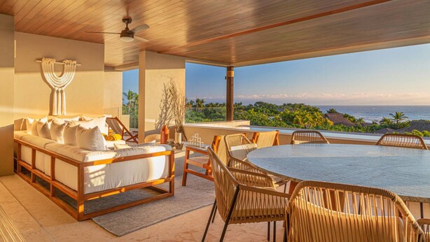 A spacious outdoor area with a wooden ceiling, a round dining table, wicker chairs, a sofa with cushions, and a view of the ocean and greenery. - 3 Bed Condo Sleeps 12 With Pool Ocean View HK (Punta de Mita)