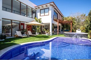 A modern two-story house with a swimming pool, outdoor seating, and a pergola. - 4 bd Villa Serenata 6 With Private Pool (Punta de Mita)